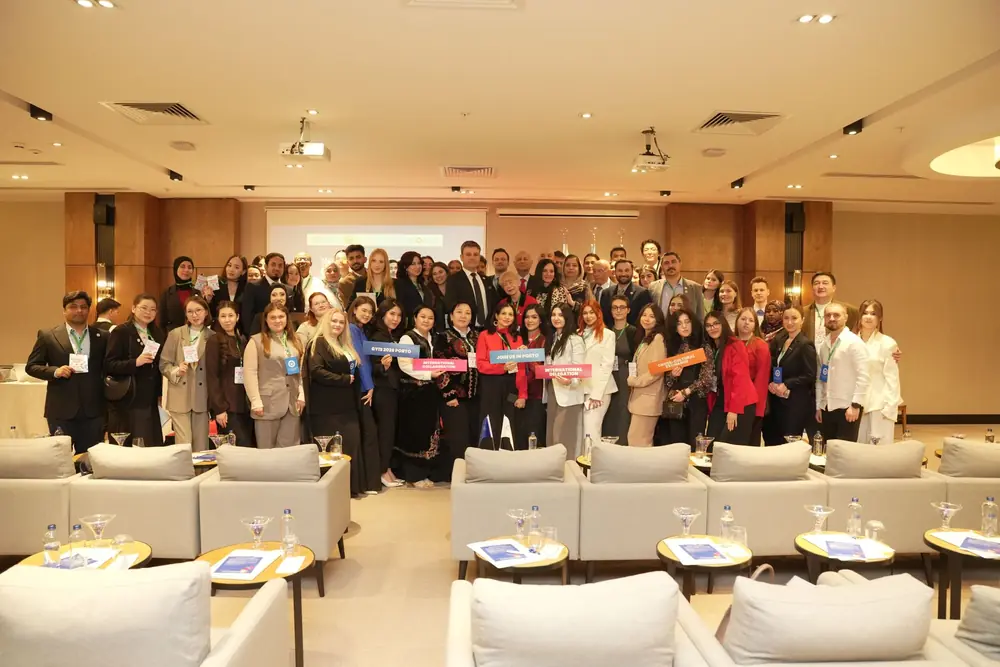 Delegates of the first Youth Forum on UN Global Goals posing as a group in Istanbul, some holding placards