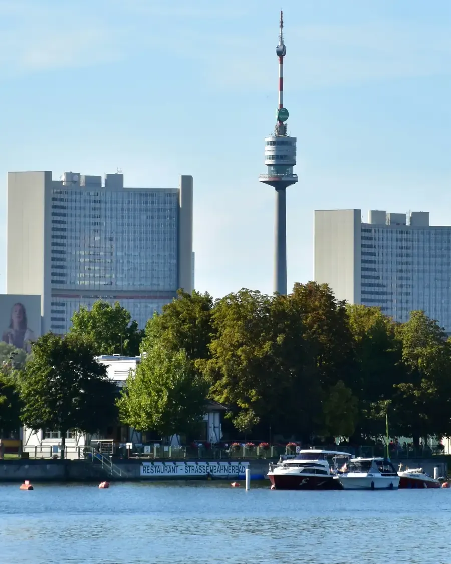 The towers of the Vienna International Centre and the Danube Tower, seen across the Alte Donau